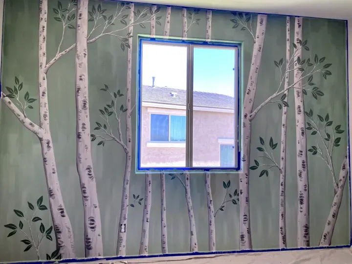 Interior aspen forest mural painted around a bedroom window