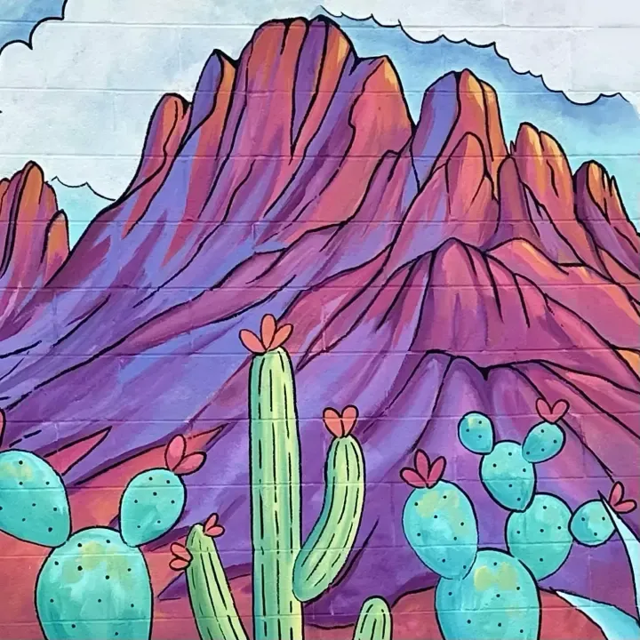 Mural detail of red rock mountains and teal prickly pear