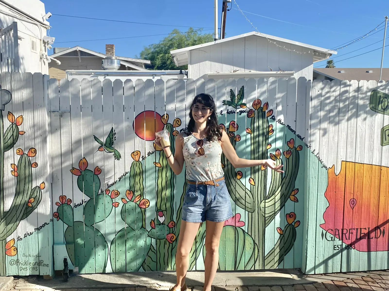 Brigitte De Marco with her flowering cactus fence mural in the Garfield Historic District, Phoenix