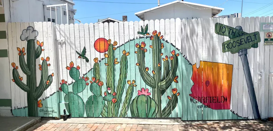 Fence mural of flowering saguaros and prickly pear in the Garfield Historic District, Phoenix