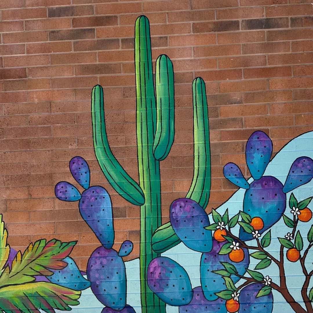 Brigitte De Marco painting a mural section