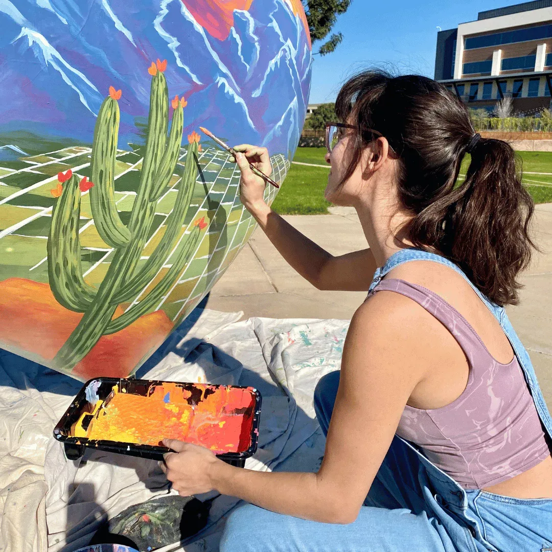 Brigitte De Marco painting the HeArt of Goodyear sculpture